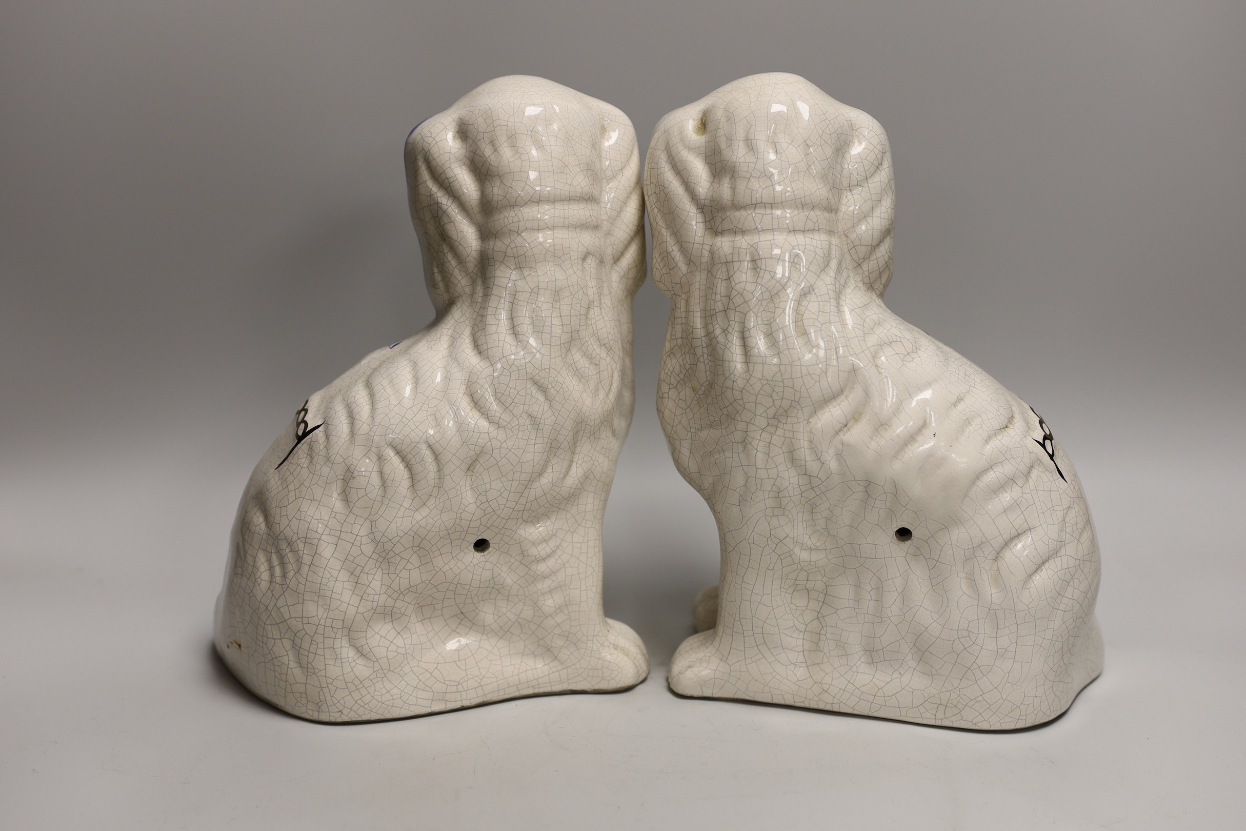 A pair of Staffordshire style comforter spaniels and two other items
